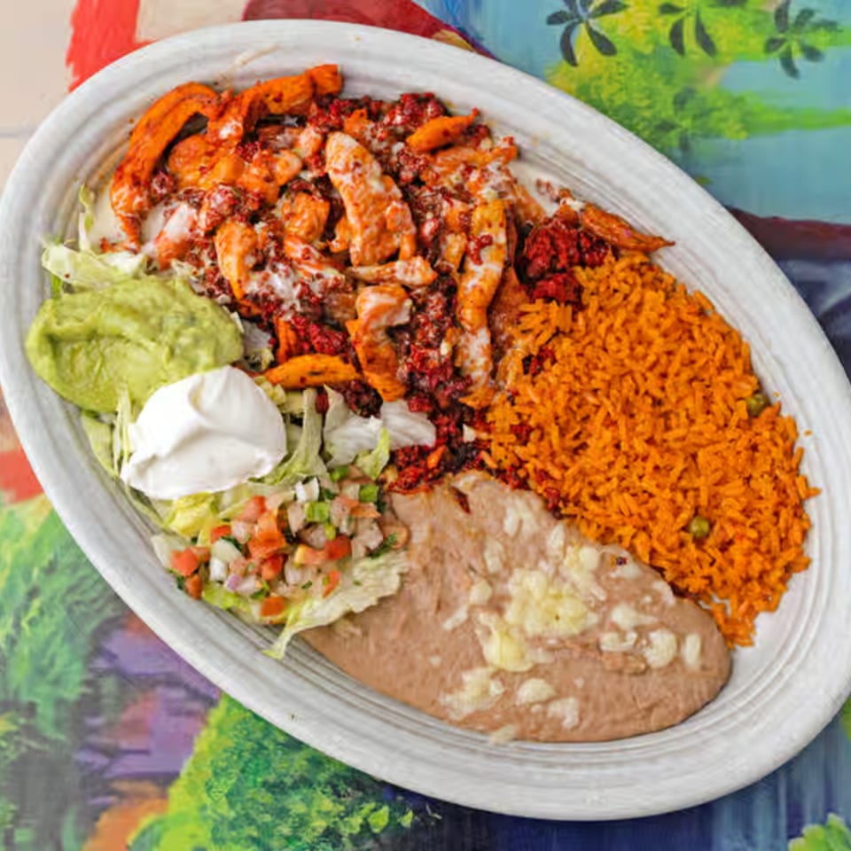 La Casita's Mexican dish with chicken, rice, beans, guacamole, sour cream, and pico de gallo.