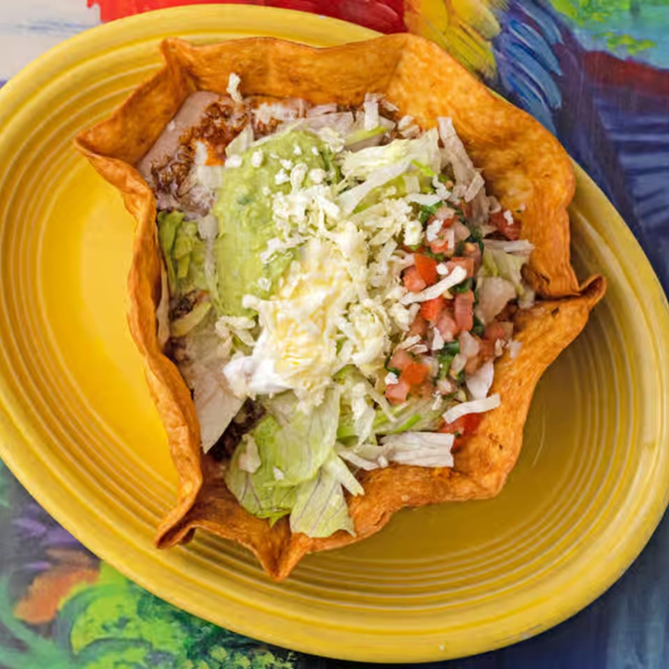 La Casita's taco salad in a crispy shell, topped with lettuce, guacamole, cheese, and pico de gallo.
